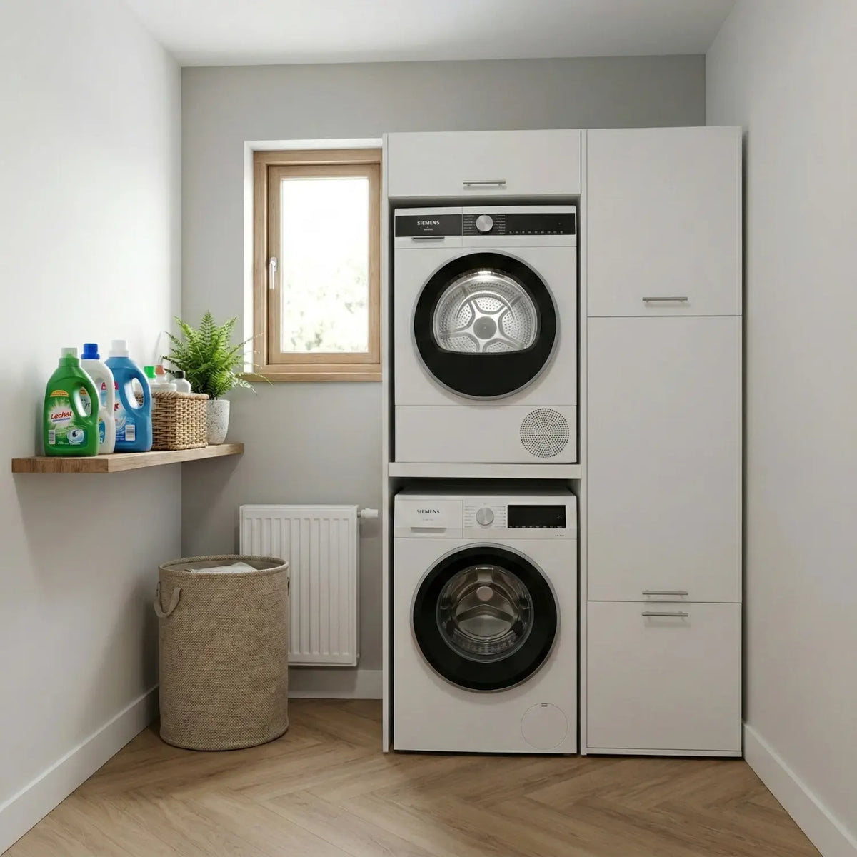White stacked washer and dryer set beside matching storage cabinets in a compact laundry room.