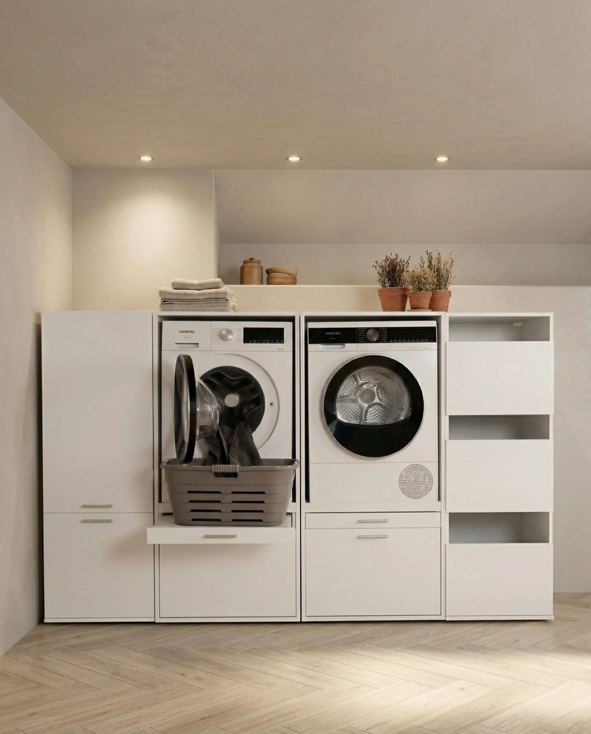 White laundry cabinet with front-loading washer and dryer, open shelving, and a pull-out folding surface.